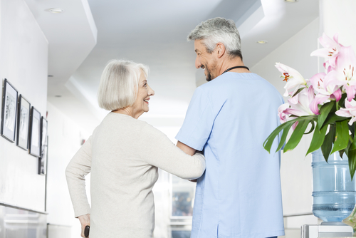 Woman being cared for by a nurse.