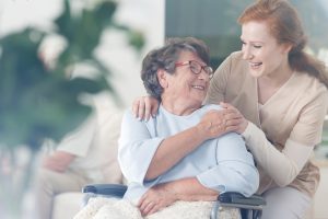 Nurse taking care of elderly woman, an example of patient centered care.