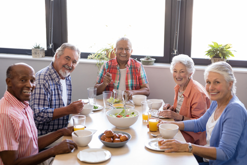 Senior citizens enjoying a healthy dinner at a restaurant.