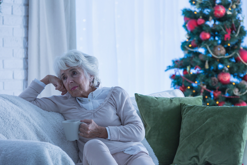 Elderly woman experiencing Seasonal Affective Disorder during Christmas.