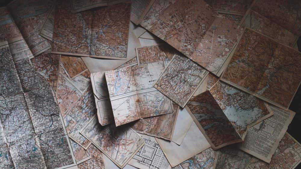 pile of maps on table, planning and goals new year 2019 business