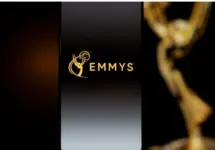 Emmys logo displayed on a smartphone screen with a blurred gold award statuette in the background^ television industry awards and digital streaming concept. Kaunas^ Lithuania - 2026 March 24