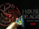 House of the Dragon HBO TV series on TV with remote control in hand. Focuse on the tv screen. Story takes place 300 years before events portrayed in Game of Thrones