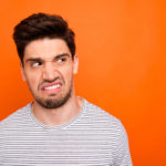 ugh-i-wont-eat-this-closeup-photo-of-disgusted-guy-look-side-empty-space-negative-reacting-wear-casual-striped-t-shirt-isolated-bright-orange-color-background