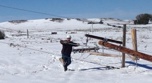 Northern Plains Electric Cooperative’s Journeyman Lineman Josh Hoffman works to restore power after a storm in southwestern North Dakota. Four NPEC linemen re-set poles near Elgin, N.D., where a storm knocked out power to more than 800 members.