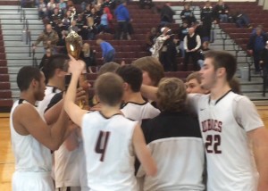 The LaMoure-Litchville-Marion Boys Basketball team celebrates their 2015 Barnes County Boys Basketball Tournament Championship. Photo by Jason Metko