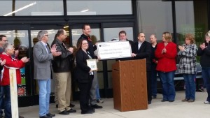 Oakes School Superintendent Josh Johnson is presented with a $2,500 check from representatives from Shopko. 