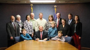 The Kulsrud Family pose with Governor Jack Dalrymple as he signs the "Right to Try" bill into effect.