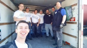 Student Colt Mavity poses with the group as they load a U-Haul truck with recently purchased water. Photo courtesy of #ND4Flint Facebook Page.