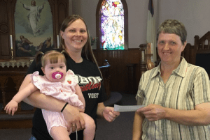 Dakota Valley Electric Cooperative’s Operation Round Up program donated more than $11,000 to area individuals and organizations. ORU board member Linda Wagner gives a check to Destinee Christensen, LaMoure.