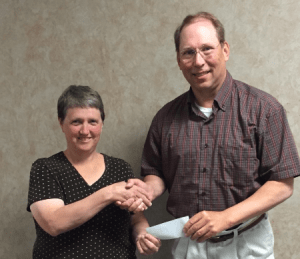 Dakota Valley Electric Cooperative’s Operation Round Up program donated more than $11,000 to area individuals and organizations. ORU board member Linda Wagner gives a check to Vince Watkins, Secretary of the LaMoure Community Development Corporation.