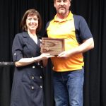 Kay Vinje presents Paul Diegel the owner of 6-D Construction with the Business of the Year Award.