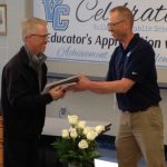 R to L; Teacher Matt Nielson hands the 2019 VCEA Friend of Education award to Scott Johnson of Valley City.