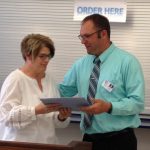 R to L; Washington Principal Chad Lueck handed the 2019 Teacher of the Year Award to Rhonda Nudell a 5th Grade Teacher at Washington Elementary in Valley City.