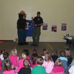 Image-4: North Dakota Forest Service fire staff teaches a classroom of students about wildland fire prevention by bringing Smokey Bear to their classroom. Remember, on YOU can prevent wildfires!