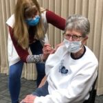 COVID vaccine: Theresa Will, RN, CCHD, administering a COVID vaccine to Edith “Karen” Magnuson of Valley City.