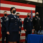 1568: Master Sgt. Lisa Narum, First Sergeant of the Year, stands on the stage waiting to be recognized while members of the official party stand behind her during the Airmen of the Year recognition ceremony at the North Dakota Air National Guard Base, Fargo, N.D., March 6, 2021. (U.S. Air National Guard photo by Chief Master Sgt. David H. Lipp/released)