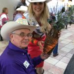 Dick Nelson: NDCHF Board member from Valley City, ND during the auction with Miss Rodeo Mandan.