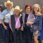 Dale Carlson: Center, pink shirt and vest with family members. Far left Jerry Stokka President of NDCHF Board. Carlson was inducted into the Pre-1970