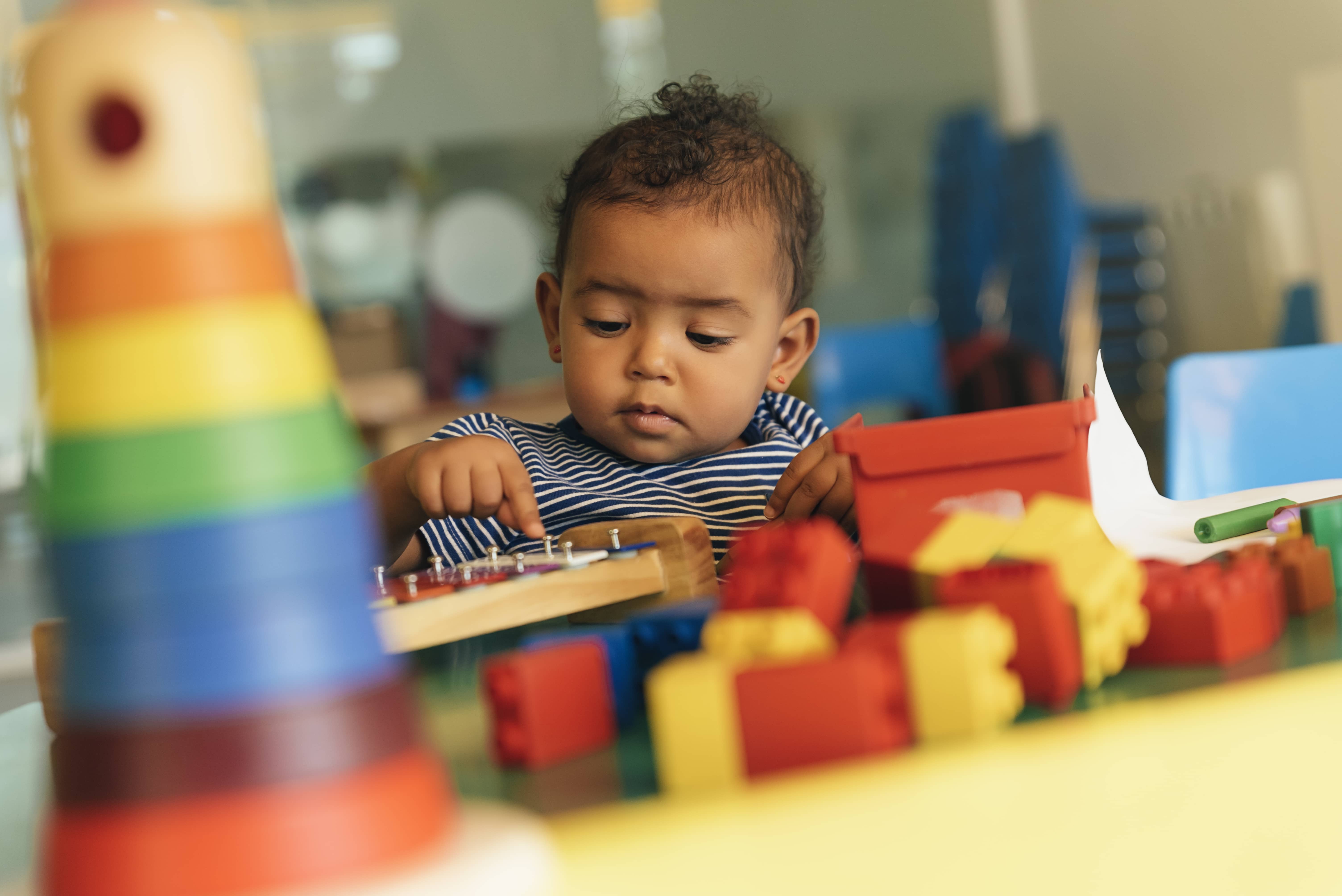 happy-baby-playing-with-toy-blocks