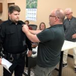 Joshua Reign: Police Chief Phil Hatcher pins on the badge.