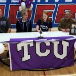 Signing: L to R; Todd Zaun, Sara Zaun, Katie Zaun and coach Dan Geurts.