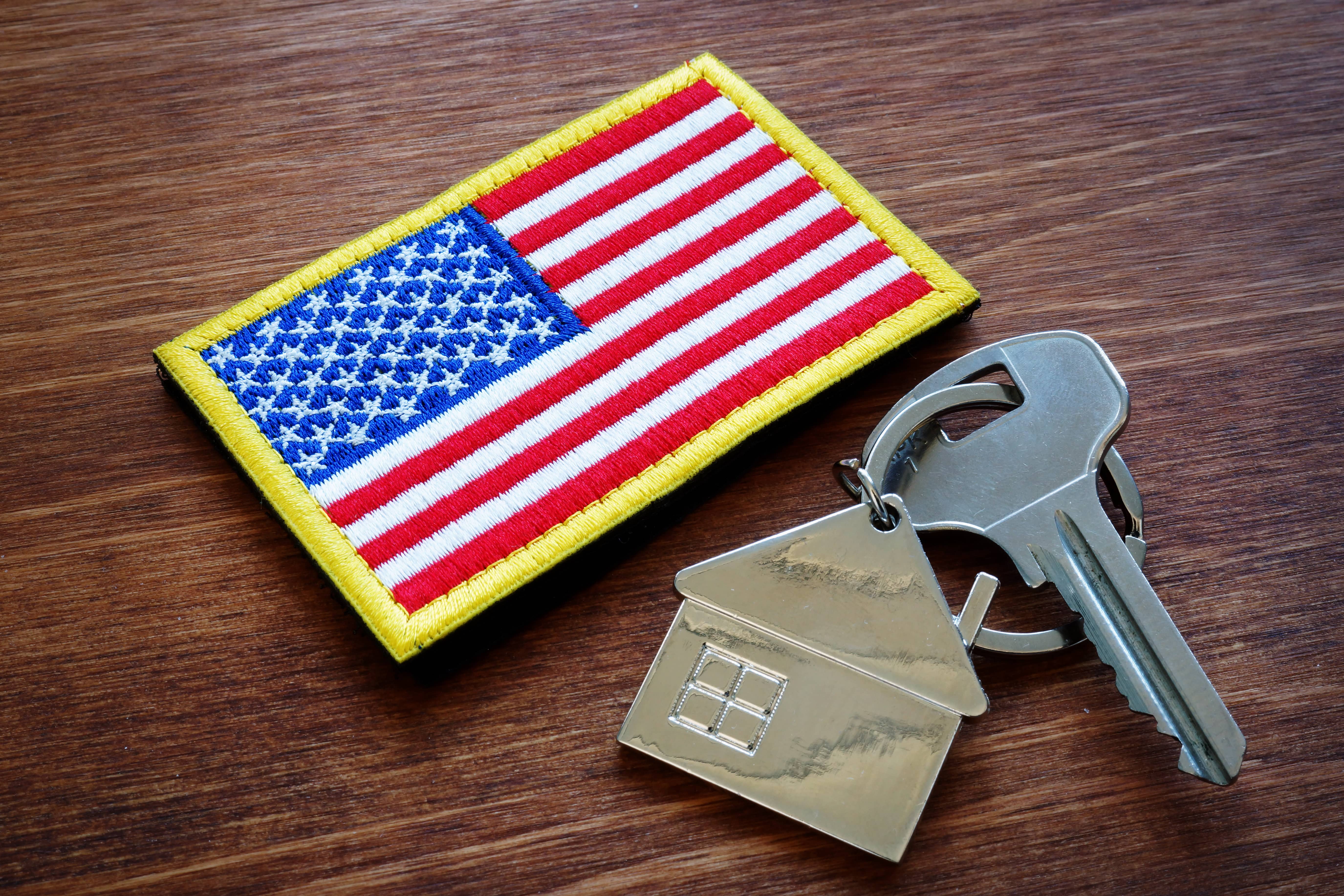 key-from-property-and-usa-flag-va-loan-mortgage-concept