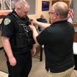 Anthony Erickson: Police Chief Phil Hatcher pins on the badge.