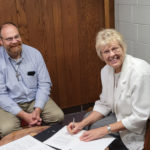 Maryvale Agreement: L to R; Steve Splonskowski, Executive Director of the newly formed Maryvale Corporation and Sister Suzanne Stahl, Regional Superior of the Sisters of Mary of the Presentation, sign the agreement turning Maryvale over to the corporation and the Diocese of Fargo.