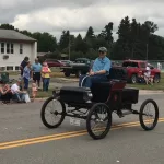 Wes Anderson: Driving the 1901 Oldsmobile.