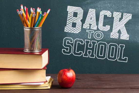 back-to-school-background-with-books-and-apple-over-blackboard