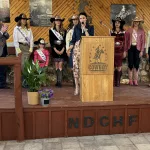 Medora: Miss Rodeo National Director Codi Miller addresses the crowd surrounded by Miss Rodeo North Dakota Grace Stanke, and Miss Rodeo South Dakota and Minnesota during the social, dinner, and auction on the Hall of Fame outdoor patio.