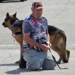 Community Days Parade: Man and his service dog watch the parade on Central Avenue June 15th. Photo submitted to NewsDakota.com