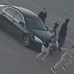Suspects in parking lot: Getting out of their vehicle.