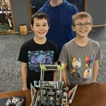 Maple Valley Robotics: Derek Bear with two of his nine students who compete in Robotics competitions.