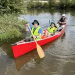 river-clean-up-4: Dr. Misty Anderson, her son Grant and Dr. James Buhr return from a fruitful afternoon of picking up debris on the river.