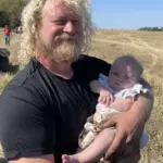 The youngest attendee: Tyler Curtis holding his four month old baby girl during the annual plowing bee.