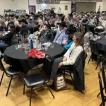 The crowd laughs loudly: During John DeBoer's stand-up comedy routine.