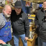 Chef Mike: Gets a hug from NDWS board director Jim Nelson, Beth Didier and other board directors thank him for being a loyal vendor for 50 years.