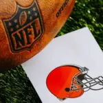 CLEVELAND^ USA^ FEBRUARY 10^ 2025: Cleveland Browns NFL team Logo and American football ball on Green Grass.