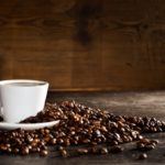 cup-coffee-with-pile-coffee-beans_1112-438