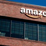 Closeup of Amazon logo on the company office building in East Palo Alto^ Silicon Valley^ San Francisco Bay Area. Amazon sign on brick building wall East Palo Alto^ California US - October 17^ 2024