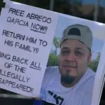 protest sign reading: "Free Abrego Garcia Now" Return Him To his family! Bring back all of the illegally disappeared! NEW YORK^ NEW YORK USA - May 1^ 2025 on International Workers' Day in Lower Manhattan.