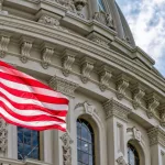 Washington DC Capitol dome detail with waving american flag