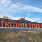 Virginia State University sign on a hill overlooking painted Greek life rocks located in the village of Ettrick in Chesterfield County^ VA. Ettrick^ Virginia USA - November 24^ 2023