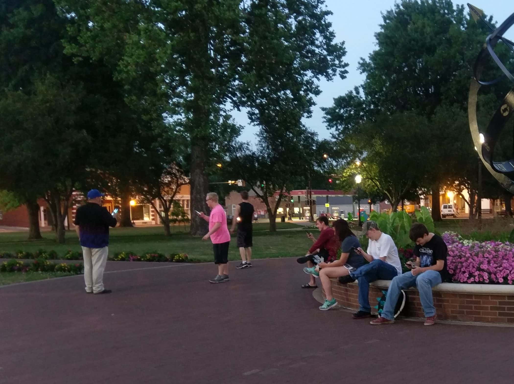People gather at Central Park in Pella to play Pokemon Go