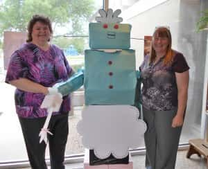 Library Director Jane Millard (left) stands with Rosie from The Jetsons (middle) and Children's Librarian Terry Clark (right)