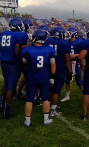 Will Whiton huddles the offense Friday night