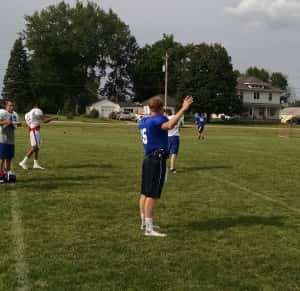 Senior Quarterback Will Whiton gets loose before a preseason practice Friday.