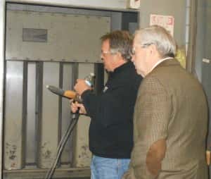 Conner (left) shows Branstad (right) some of the manufacturing equipment at Power Lift
